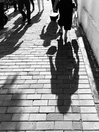 Low section of people walking on street