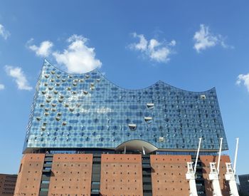 Low angle view of buildings against blue sky