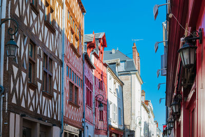 Low angle view of buildings against blue sky