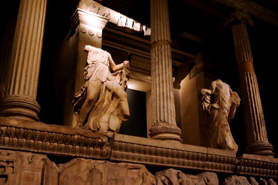 Low angle view of statue against historic building