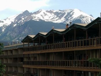 Houses against snowcapped mountain