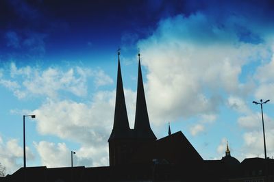 Low angle view of silhouette building against sky