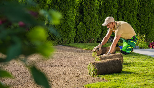 Side view of man working at farm