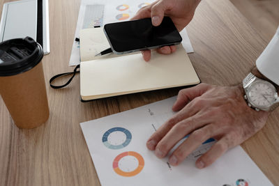 Cropped hands of man using digital tablet