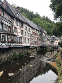 Building by river against sky