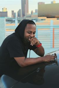 Young man using mobile phone while sitting outdoors