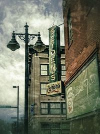 Low angle view of building against cloudy sky