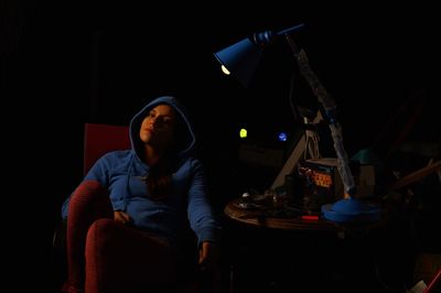 Young woman sitting on stage