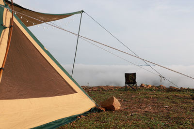 Tent on field against sky