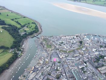 High angle view of cityscape by sea against sky