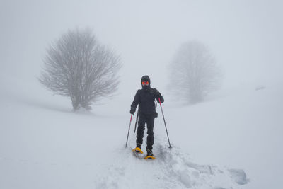 Full length of man skiing on snow covered land