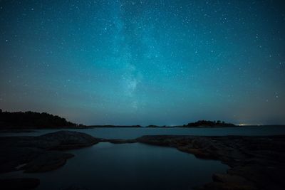 Scenic view of lake against star field at night