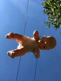 Low angle view of man on swing