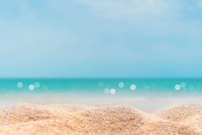 Surface level of beach against clear sky