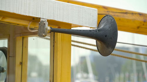 Low angle view of metal hanging on wood