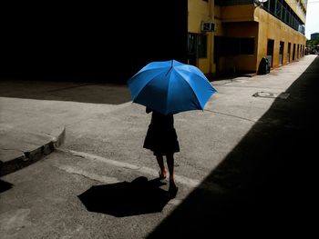 Woman walking with umbrella