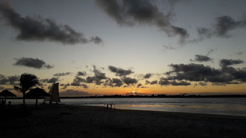 Scenic view of beach against sky during sunset