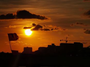 Low angle view of silhouette buildings against sky during sunset