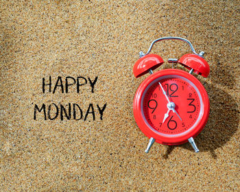 Close-up of clock on sand