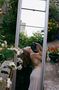 Woman photographing through window