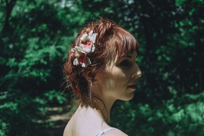 Close-up of woman wearing flowers