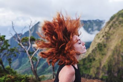 Close-up of young woman against trees