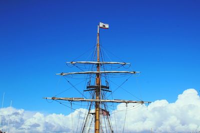 Low angle view of mast against blue sky