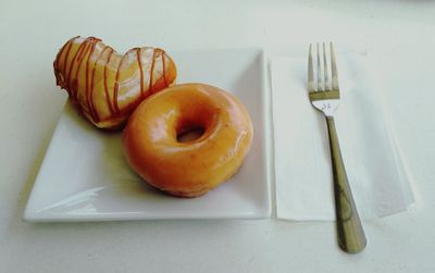 Close-up of donuts in plate on table