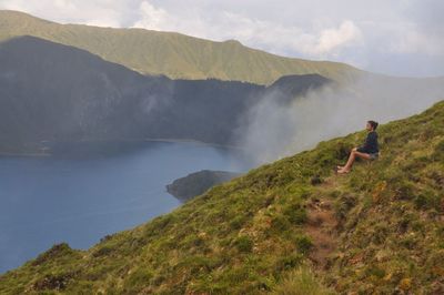 Woman sitting on mountain