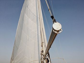 Low angle view of sailboat against clear blue sky