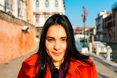 Portrait of a smiling young woman in city