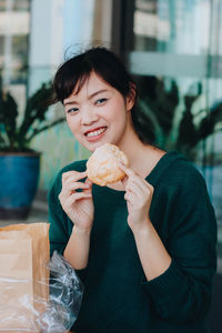 Portrait of a smiling woman holding ice cream