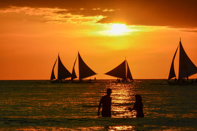 Silhouette of people at sunset