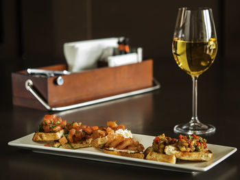 Bruschettas served in tray by drink on table