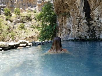 Scenic view of sea against rock formation