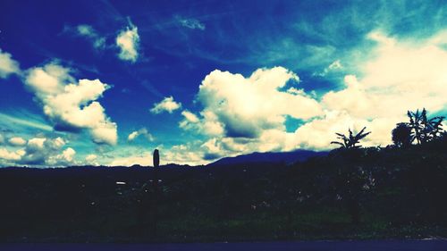 Scenic view of mountains against cloudy sky