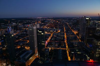 High angle view of illuminated buildings in city at night