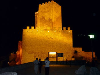 Illuminated tower against sky at night