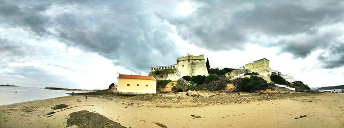 View of beach against cloudy sky