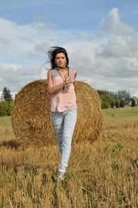 Portrait of woman walking on grassy land