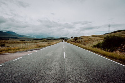 Road passing through landscape against sky