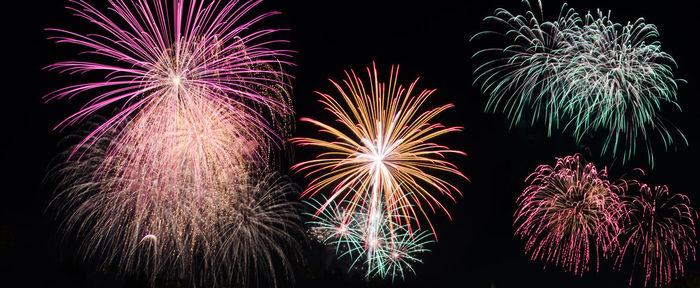 Low angle view of firework display at night