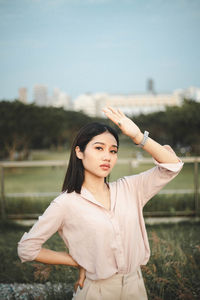 Happy woman standing against sky