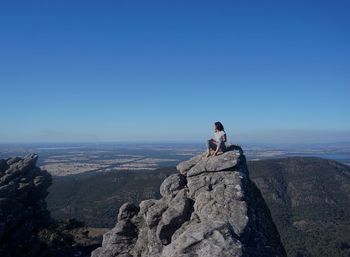 Woman standing on rock