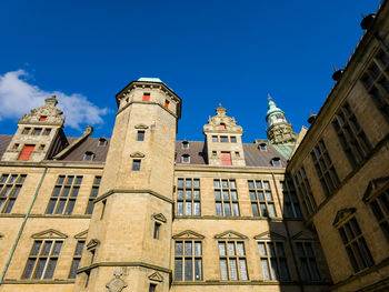 Low angle view of building against clear blue sky