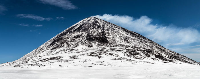 Low angle view of snowcapped mountain against sky