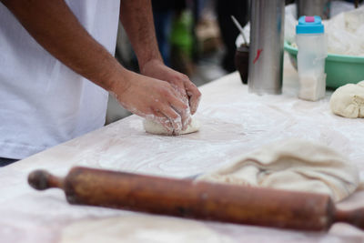 Midsection of man preparing food at table