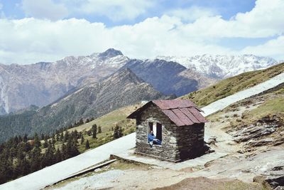 High angle view of woman at house against sky