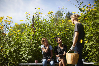 Male and female florists communicating at yard