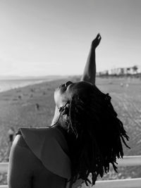 Low section of woman with dog at beach